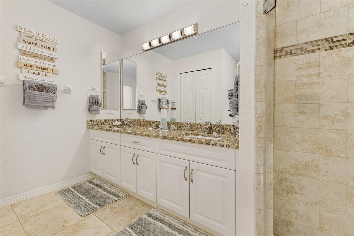 Primary ensuite bathroom with dual sink.