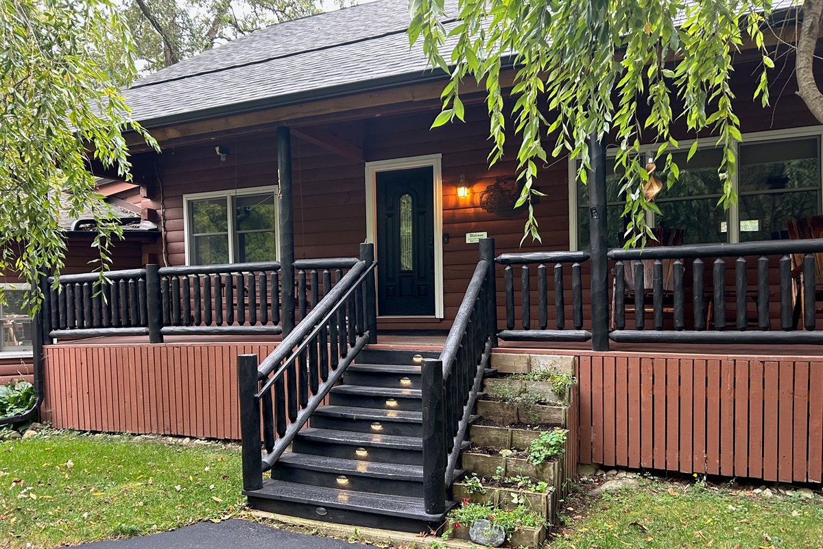 Stairs leading to the Log Cabin are lit at night.