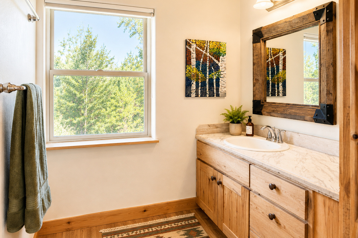 A big window with views of the Montana countryside fills the bathroom with natural light, making your morning routine feel calm and unhurried.