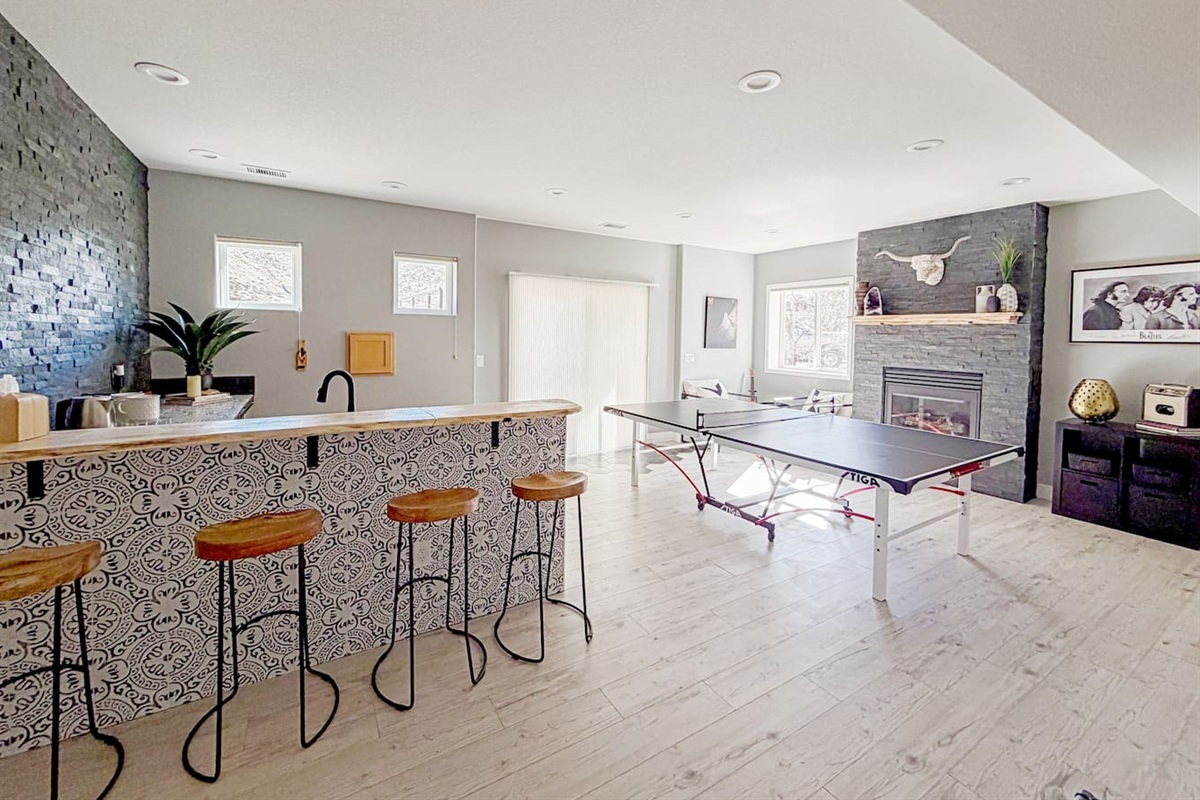 Tons of natural light and sliding doors fill the open space with natural light, creating a welcoming area for relaxing and entertaining in our basement game room!