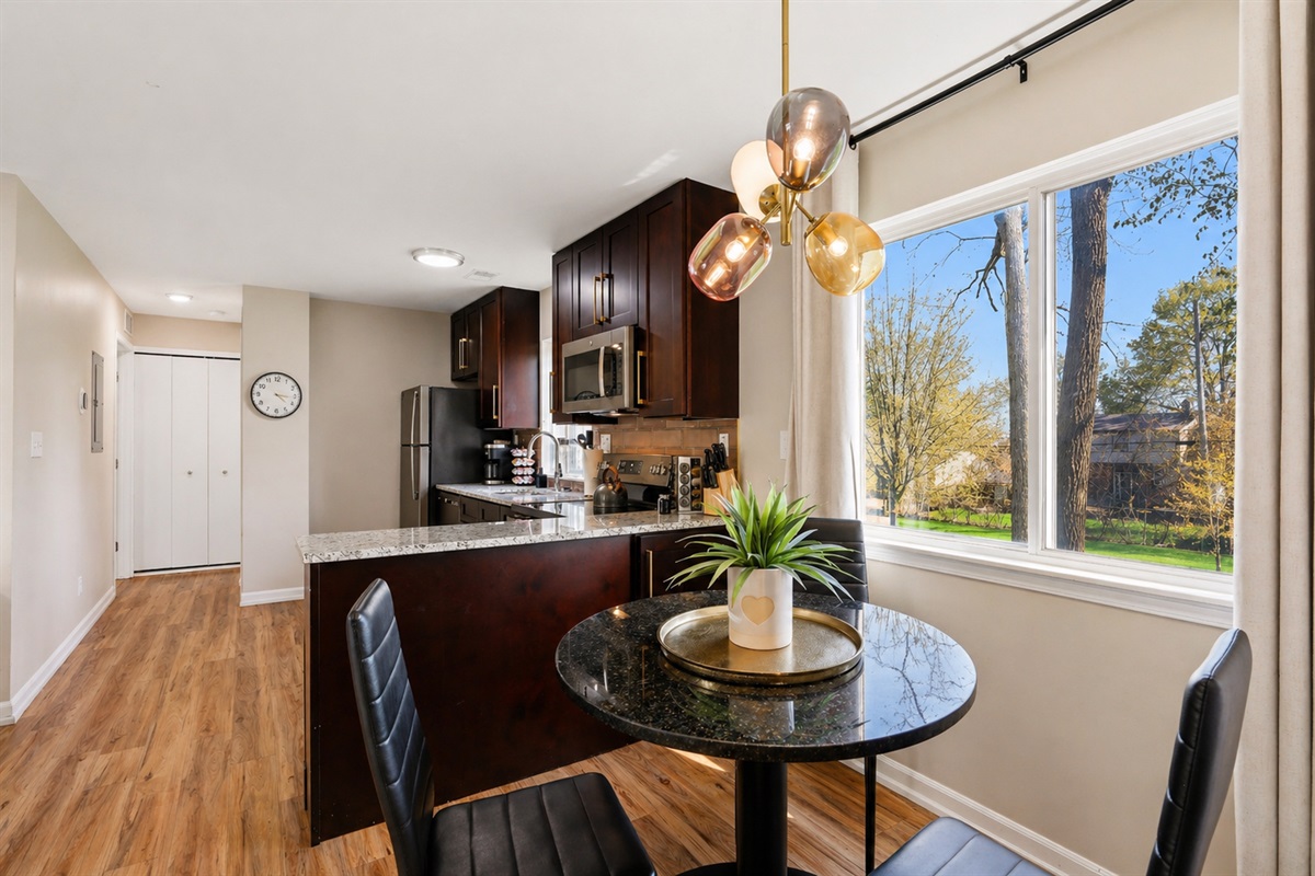 Enjoy gatherings in your charming dining room with a view. A cozy space to share meals and create wonderful memories.