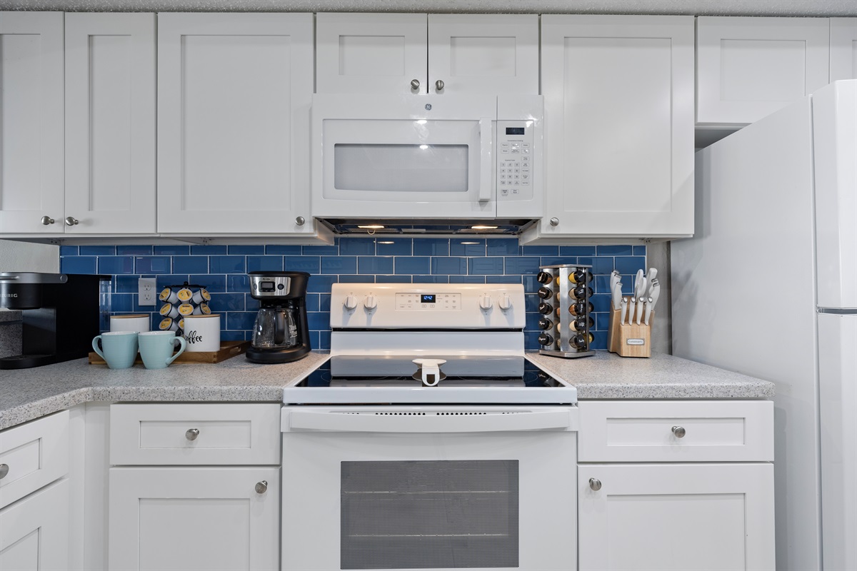 Fully stocked custom kitchen open to the living room.