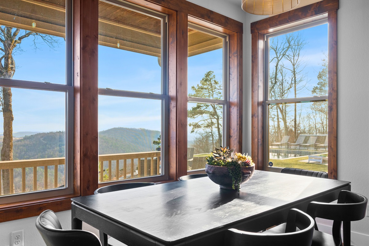 Start your morning with coffee at this table as sunlight fills the room and the hills roll out beyond the deck.