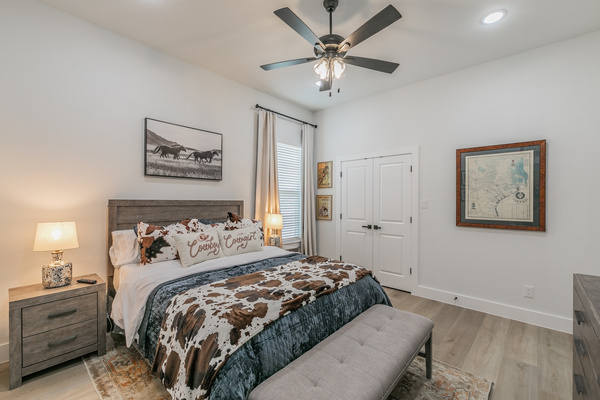 The Rodeo Room with queen bed, smart TV, ceiling fan and clothing storage