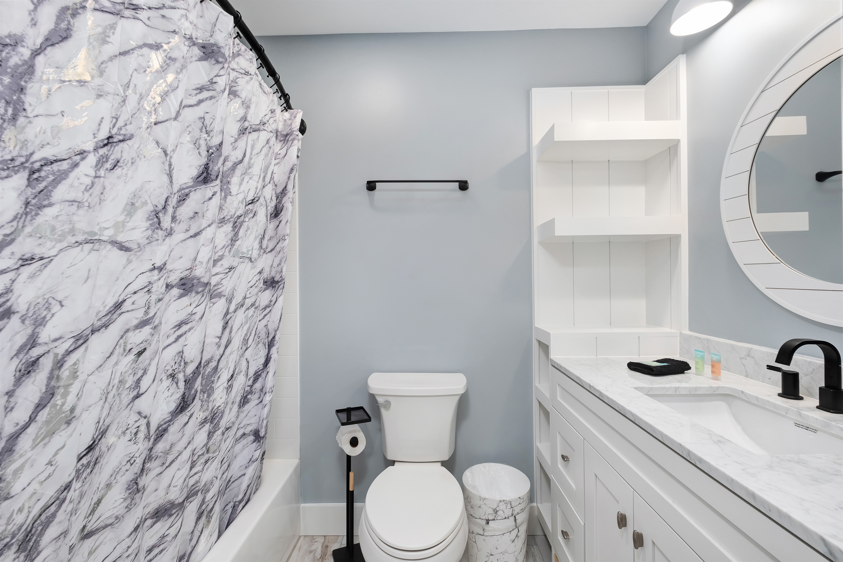 Unwind in this beautifully designed bathroom featuring a sleek marble countertop, elegant fixtures, and a calming beach-themed decor. Perfect for a refreshing start to your day or a relaxing evening.