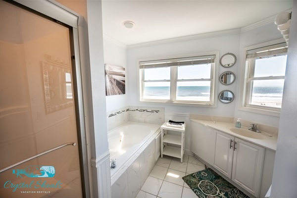 The master bath features a jetted tub, large shower, and ocean views
