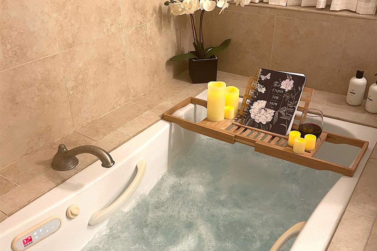  Primary bathroom has a built-in 6-foot jacuzzi whirlpool tub that includes a whirlpool jets and hot tub feature. The hot tub feature keeps the water temperature at a consistent heat of 101 degrees Fahrenheit.