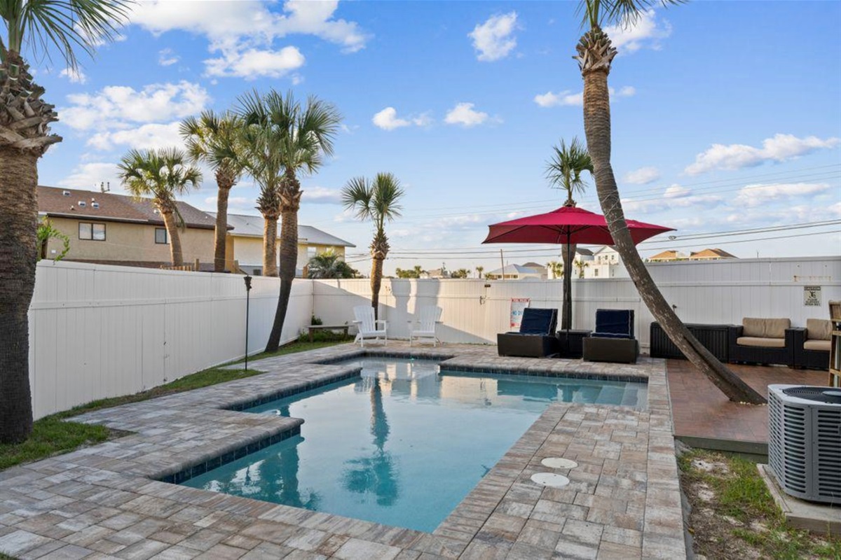 Fenced private pool with seating