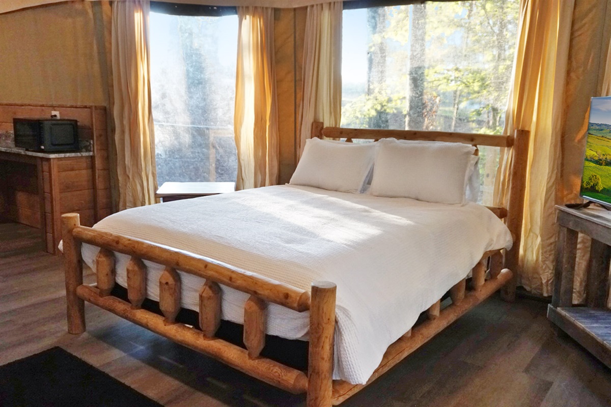 Enjoy sunlit mornings and nature views from this stylish wooden bed haven!