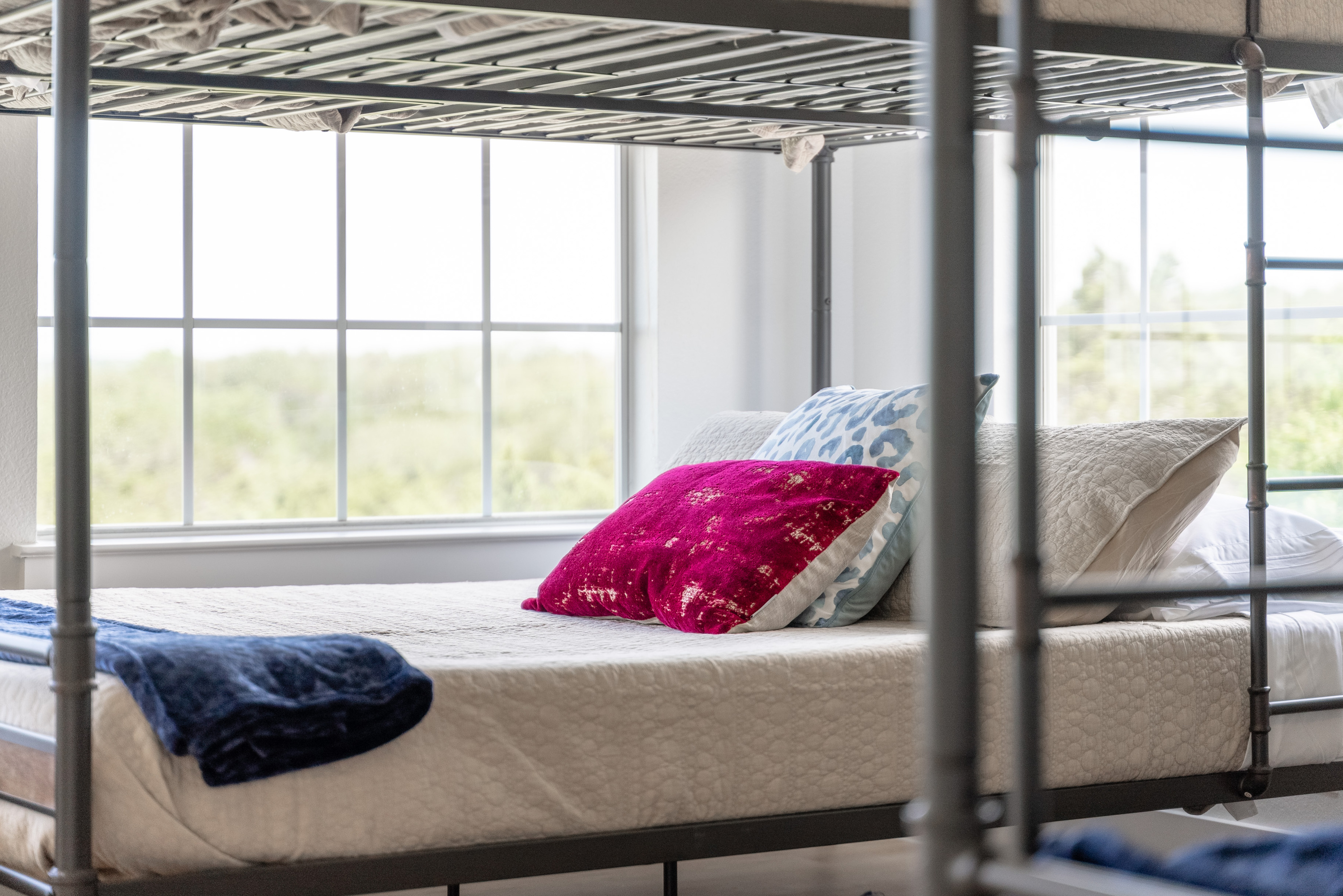Cozy reading nook tucked beside the primary bedroom's picture windows.