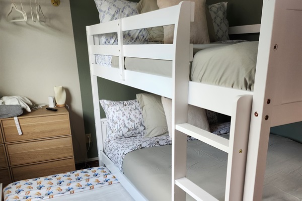 Spacious full-over-full bunk bed with twin trundle (lower bed suitable for toddlers).
