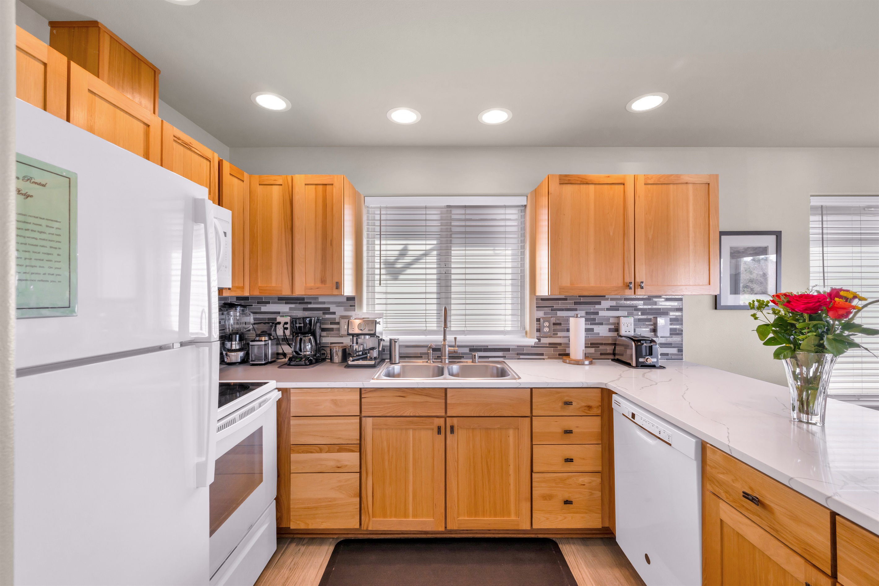Fully-stocked kitchen with stainless steel cookware and supplied staples