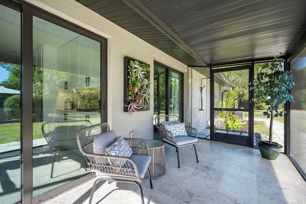 Tucked just off the home’s edge, this screened-in lanai offers a private perch to sip, read, or simply enjoy the view