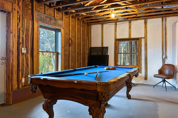 The basement has a game room with a pool table and ping pong table