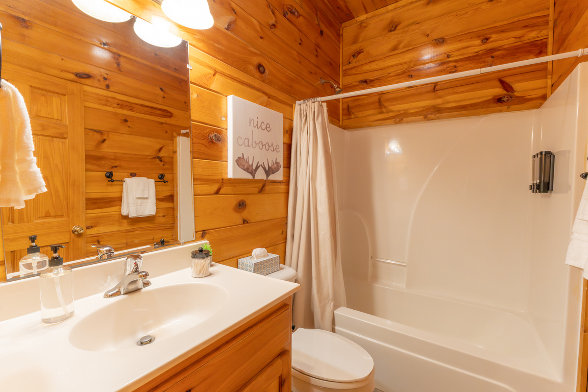 The ensuite bathroom has a tub-shower combo.
