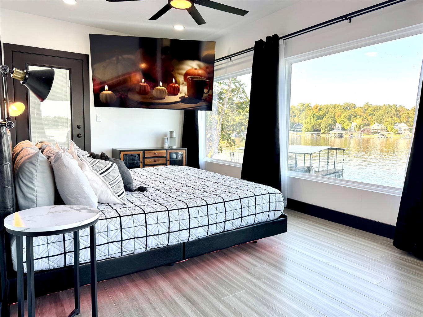 Primary Bedroom has king bed with an ensuite bathroom, 85" TV, Kuerig coffee maker, and private balcony access.