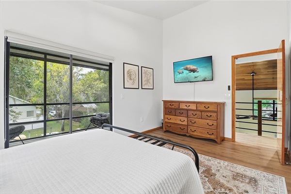 Upstairs queen bedroom with private balcony and Roku TV