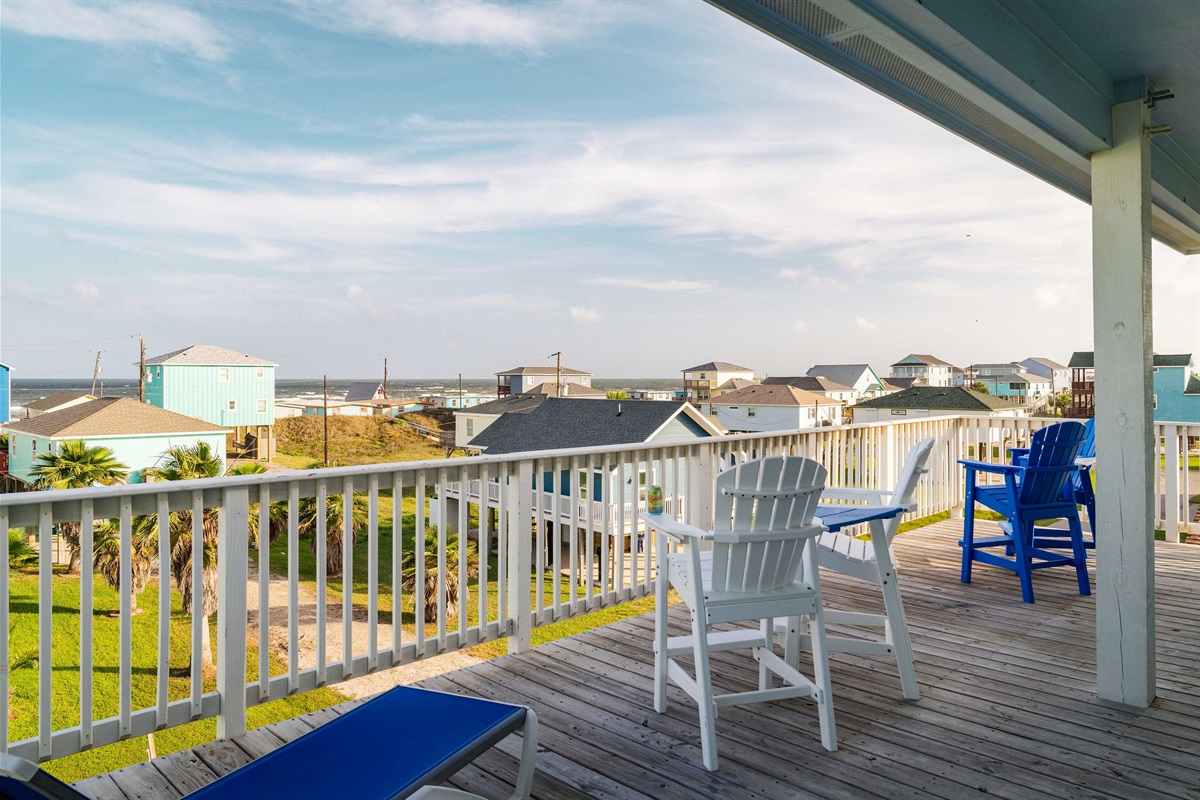Blue + white deck chairs — partial Gulf view from the top deck.