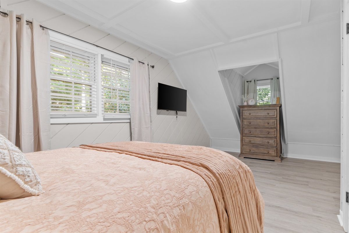 Upstairs bedroom w/ dresser and smart TV