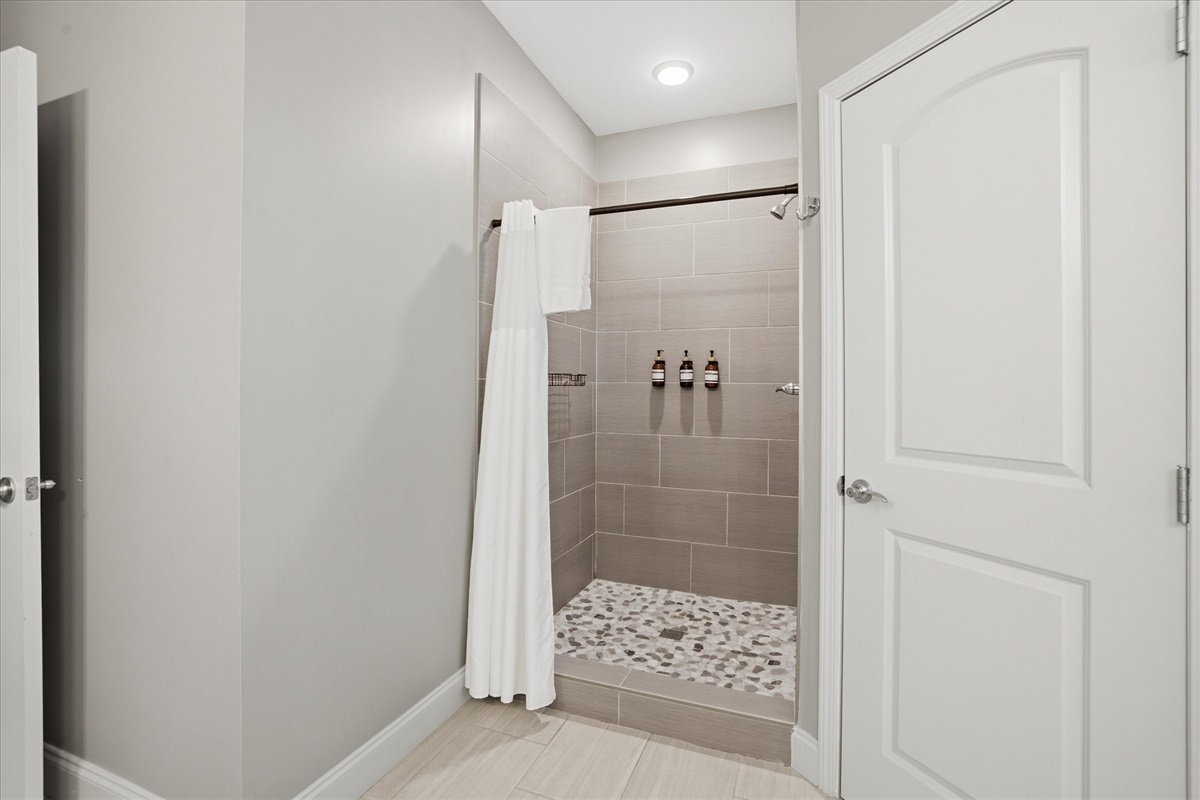 Step into the walk-in stone shower and reset. It’s spacious, simple, and designed to feel like a quiet moment after a full day out.