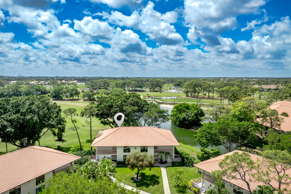 Aerial view showcasing lush golf course, water features, and serene surroundings