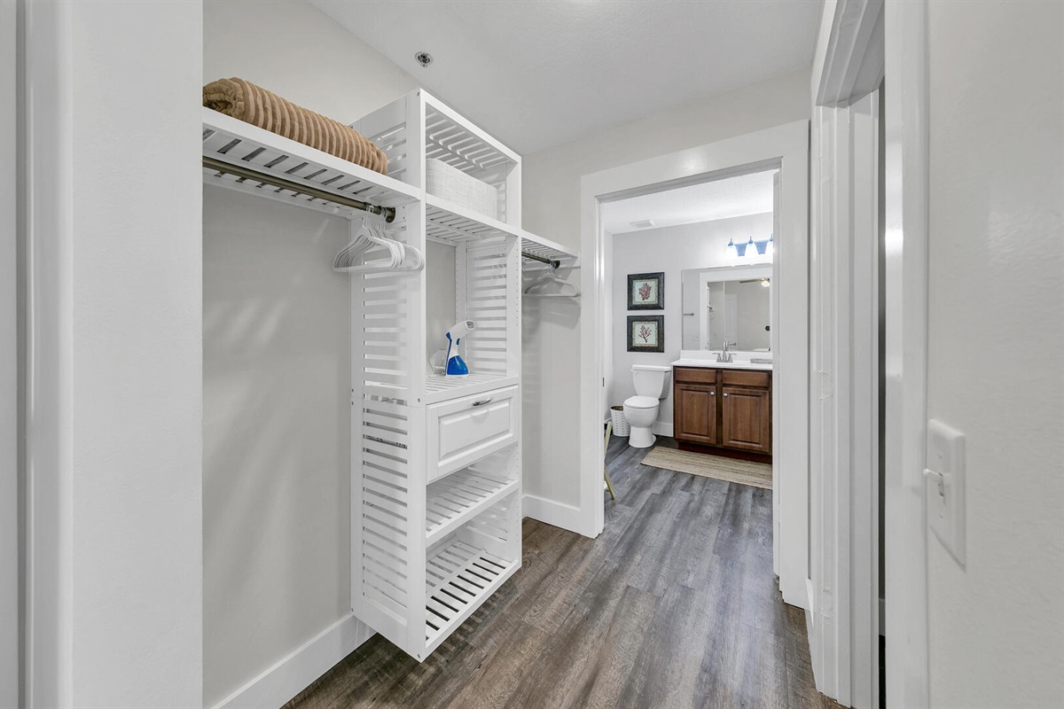 Master bedroom open closet, clothes steamer & hangers.