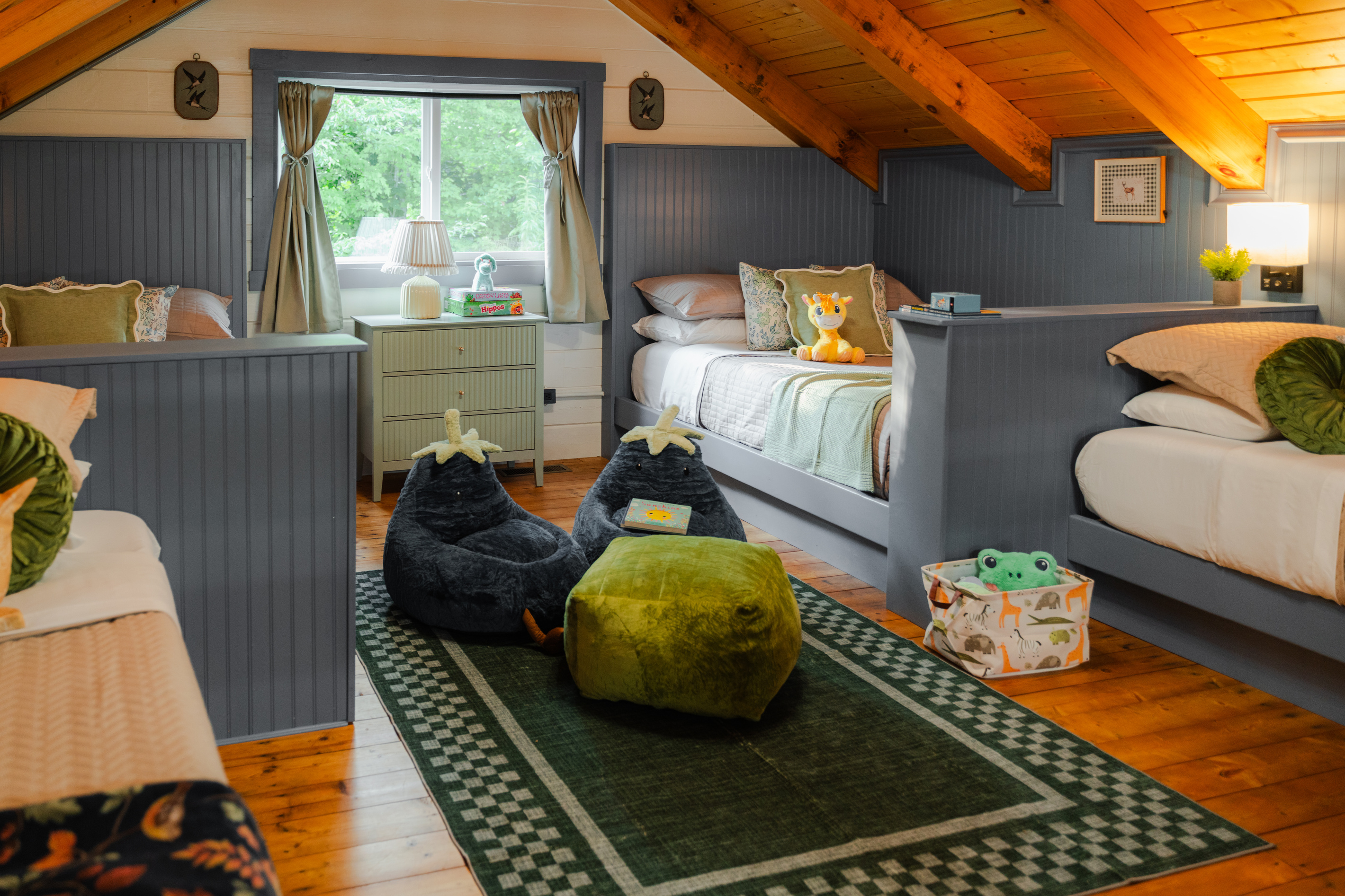 A thoughtfully designed kids’ loft with custom-built beds - two twin beds and two full beds, creating a fun and cozy sleeping space for families.