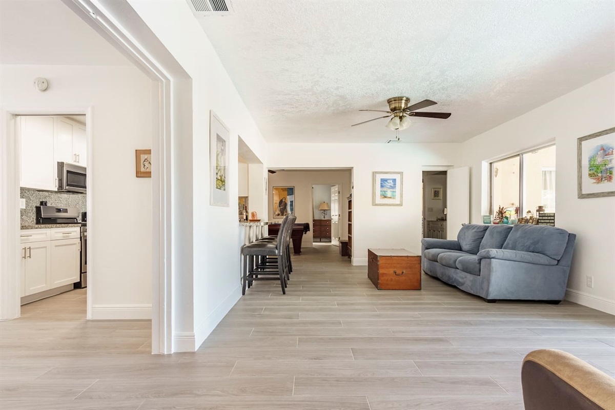 Florida room with the Game room in the back and the kitchen to the left.