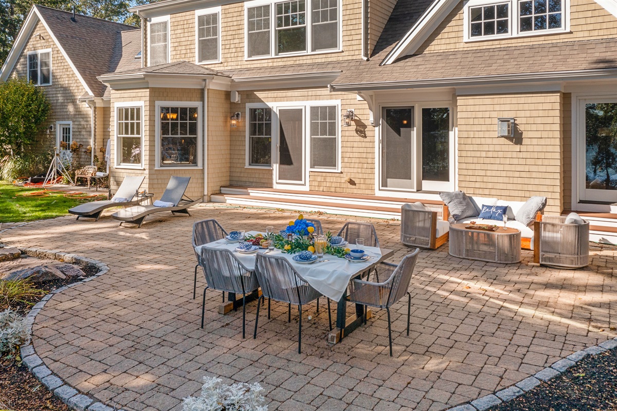 A full layout of lakeside living—grill, firepit, seating, and the water just steps away.