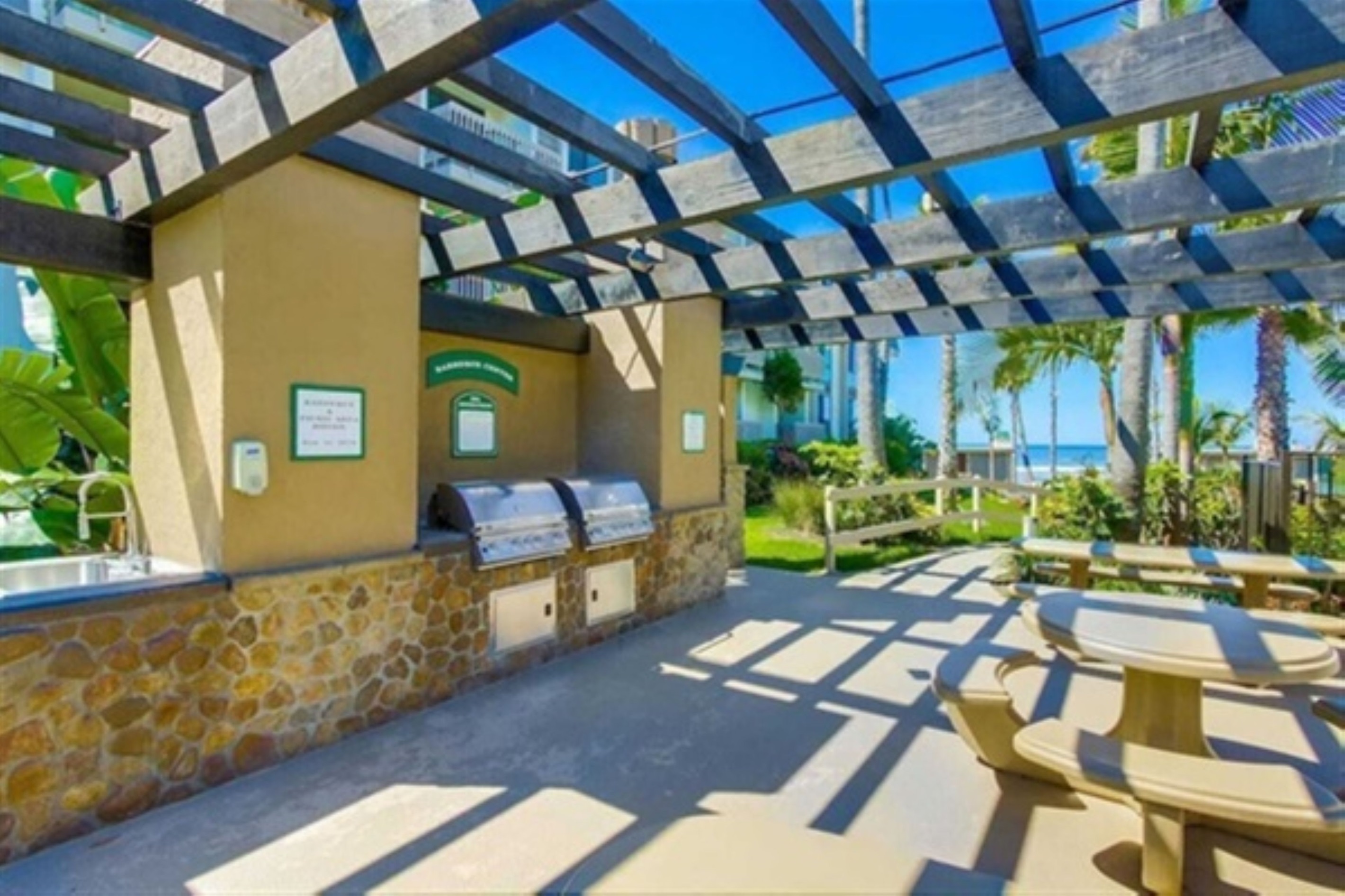 Community barbecue area overlooking the pool