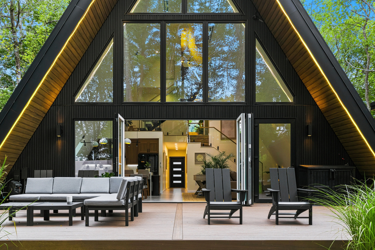 Black roof, new timber, glass, and the forest floor - Find your still place