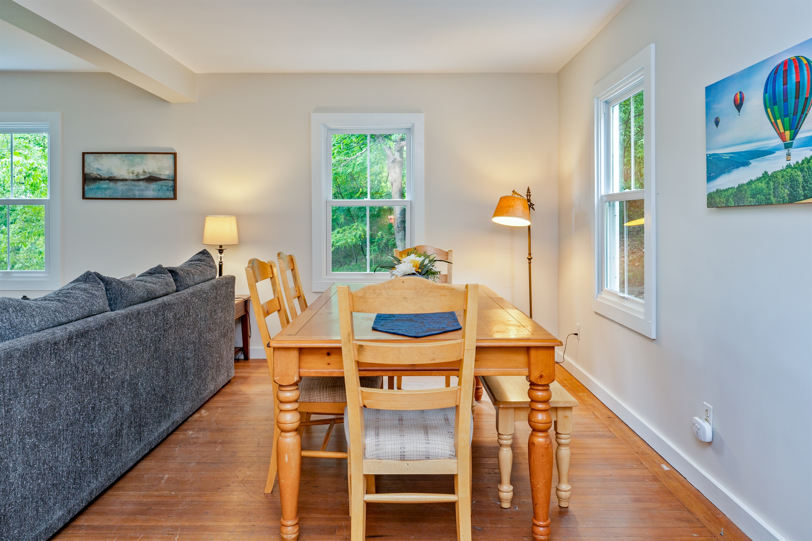 Share meals and memories at a warm wooden dining table, framed by natural light and cheerful décor.