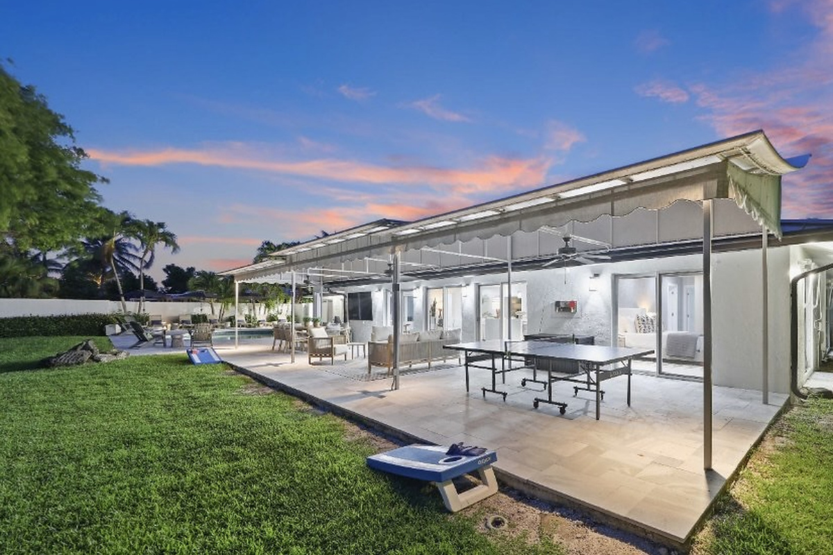 Play ping-pong, relax on the covered patio, or wander toward the canal and pool from this easy outdoor living space.
