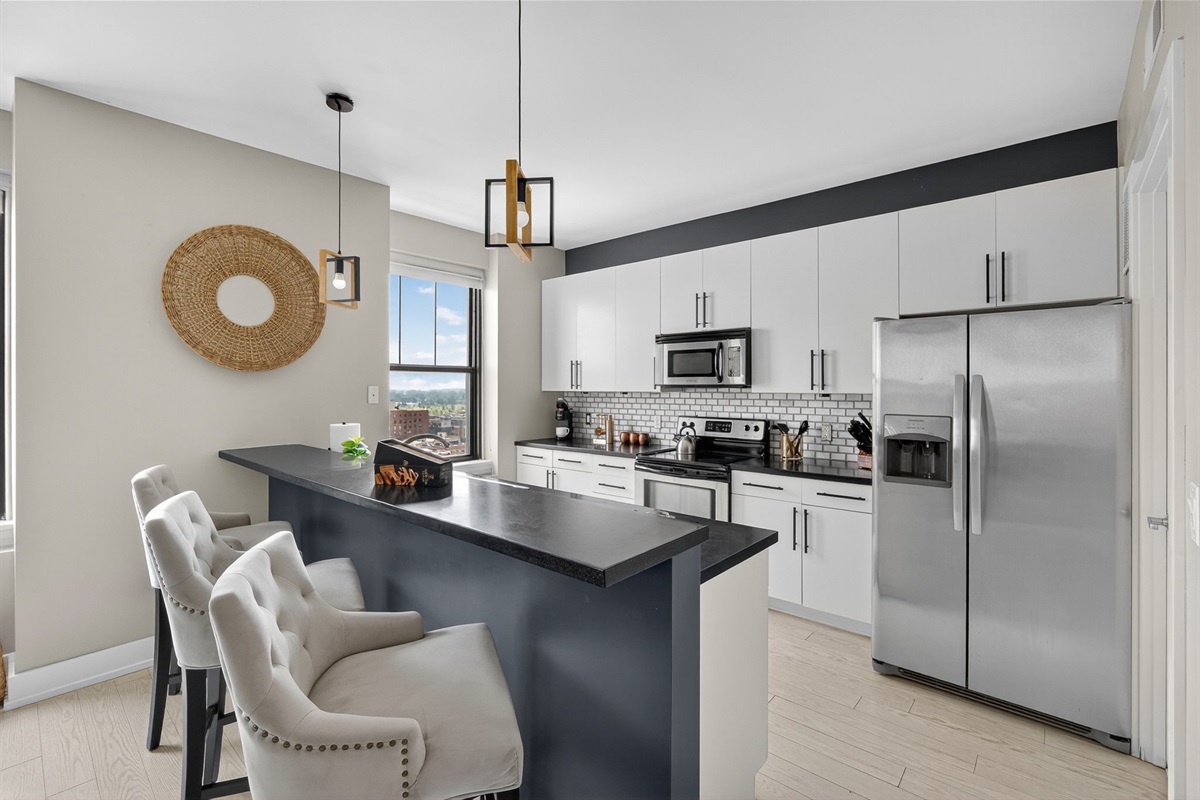 Sleek and functional kitchen island featuring a double sink, modern fixtures, and a view into the open-concept living space.