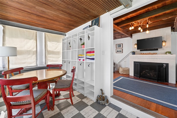 Step into this coastal cottage and you’ll find a welcoming game table and a spacious living room perfect for gathering and relaxing.