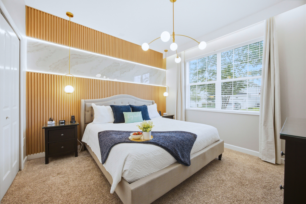 Elegant King Bedroom-downstairs
Relax in this beautifully designed king bedroom featuring a stunning wood-accent wall, soft ambient lighting, luxurious bedding, and elegant gold finishes.