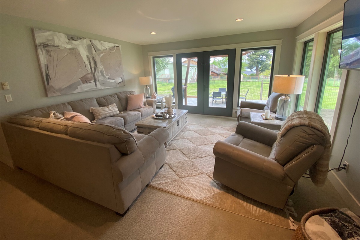 The formal living room features Peek a boo view of the water and has double doors to extend the living space to outdoor dining.