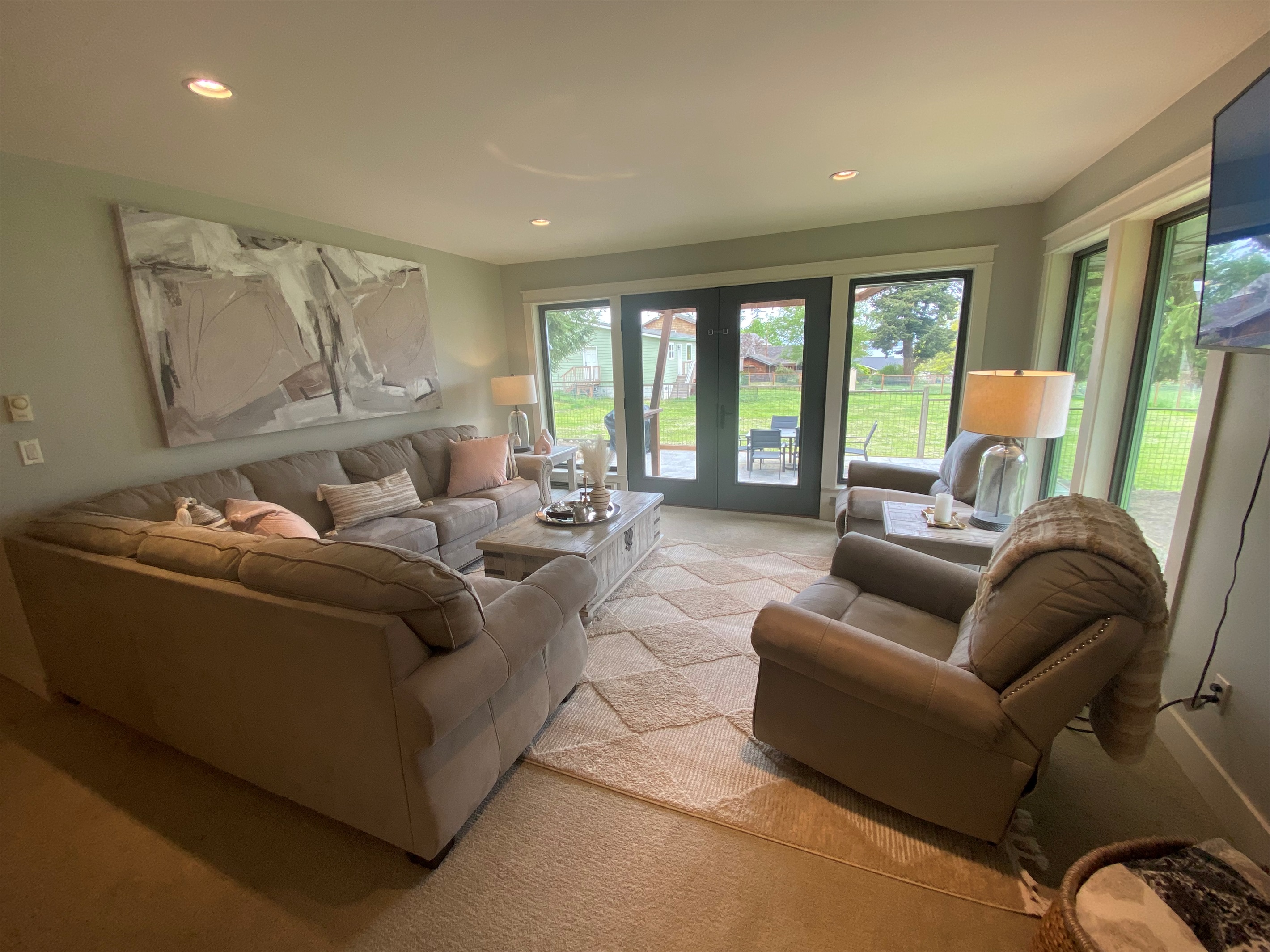The formal living room features Peek a boo view of the water and has double doors to extend the living space to outdoor dining.