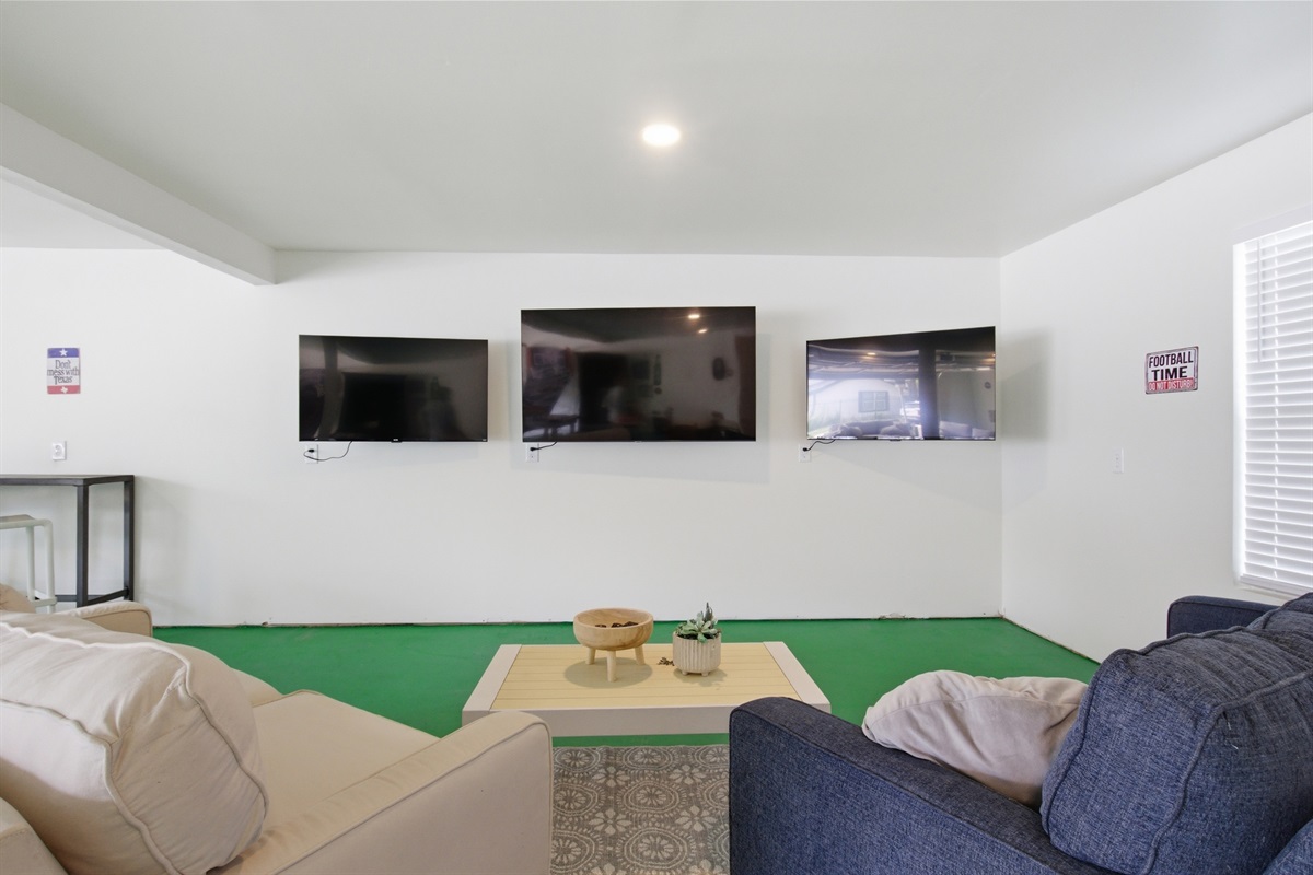 Game Room lounge zone with sectional seating and 60" Smart TV. Watch the Cowboys pregame then walk to the stadium. 1,000 sq ft of entertainment space included.