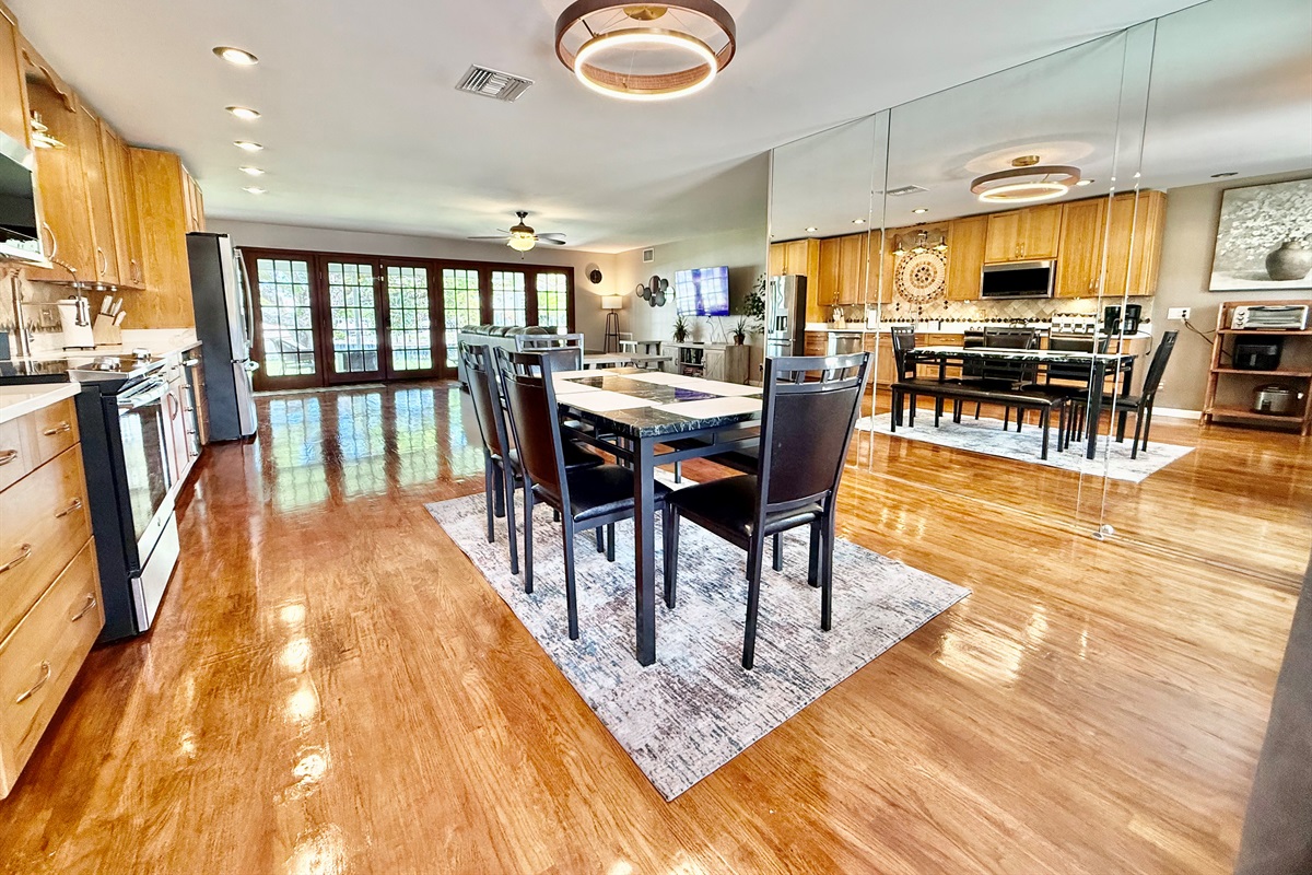 Enjoy meals together in this beautifully designed dining area, set within an open floor plan that flows seamlessly from kitchen to living room—perfect for both casual bites and special gatherings.