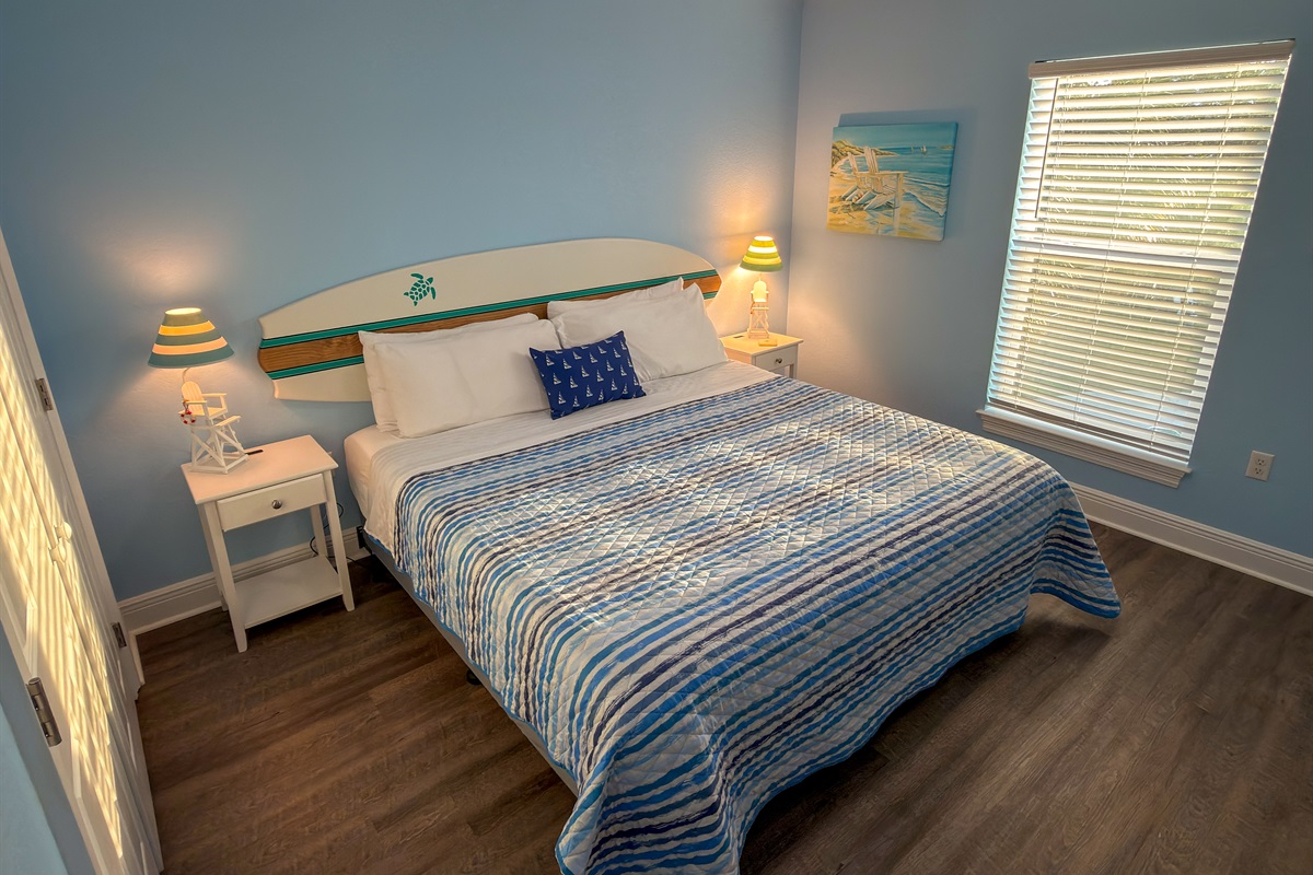 Second Floor Bedroom 3 brings a bright coastal feel with soft ocean-blue tones, beach-inspired décor, and a cozy space designed for restful nights.