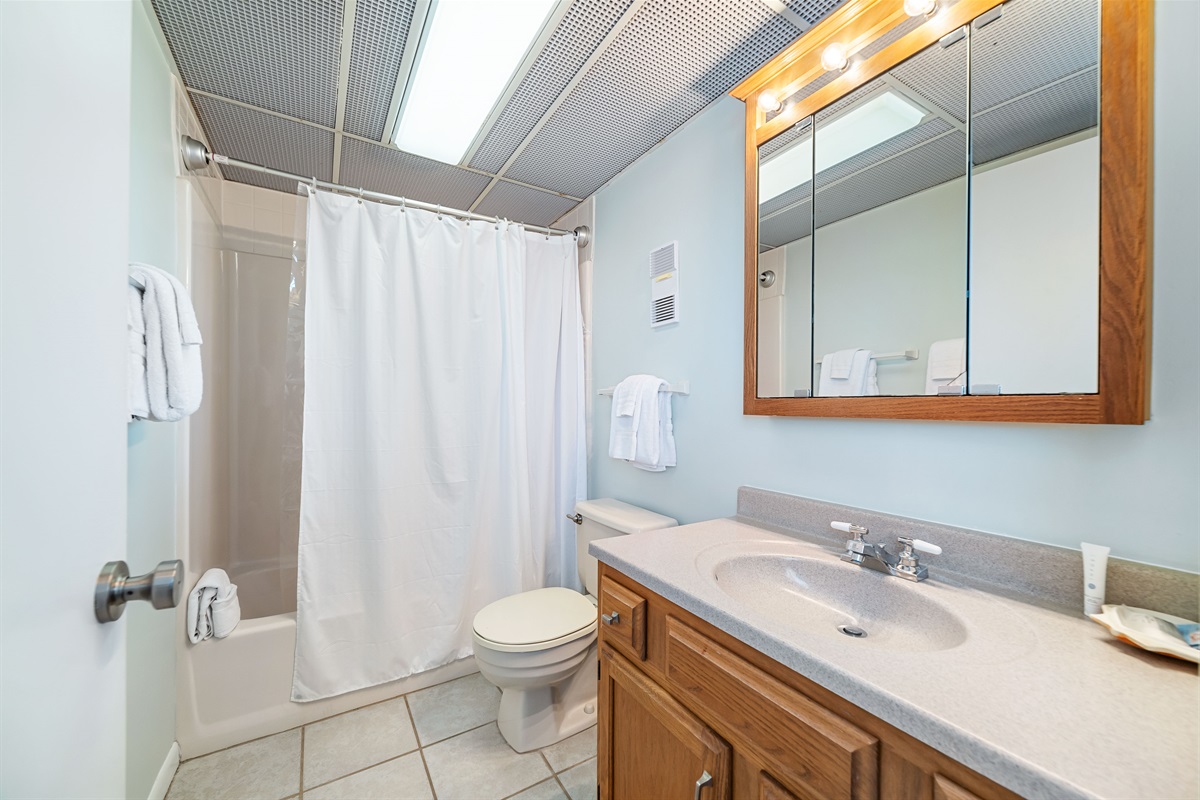 Enjoy the convenience of this well-appointed primary en-suite bathroom. We provide fresh towels and essential toiletries for your comfort.