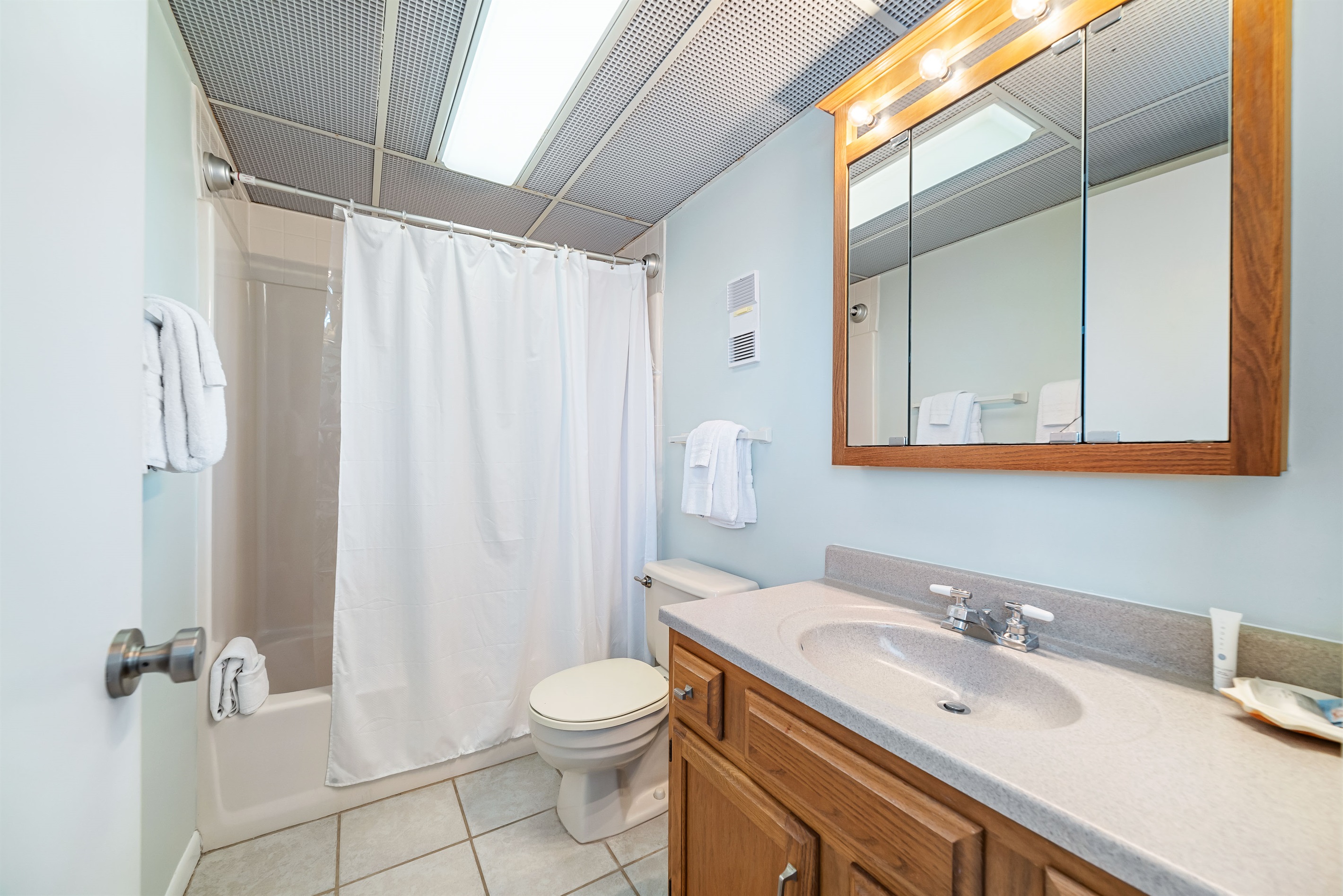 Enjoy the convenience of this well-appointed primary en-suite bathroom. We provide fresh towels and essential toiletries for your comfort.