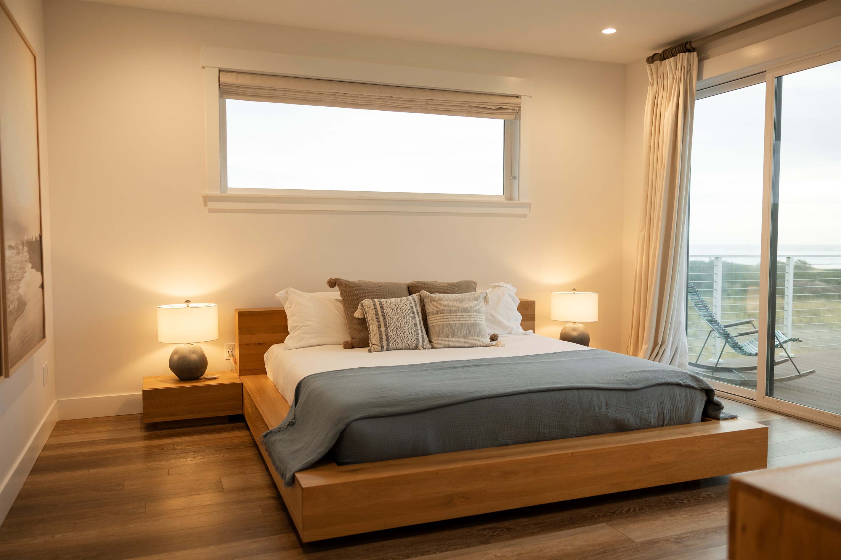 {Master Bedroom} Spacious upstairs primary suite featuring a king bed, private fire pit balcony, and ensuite bath.