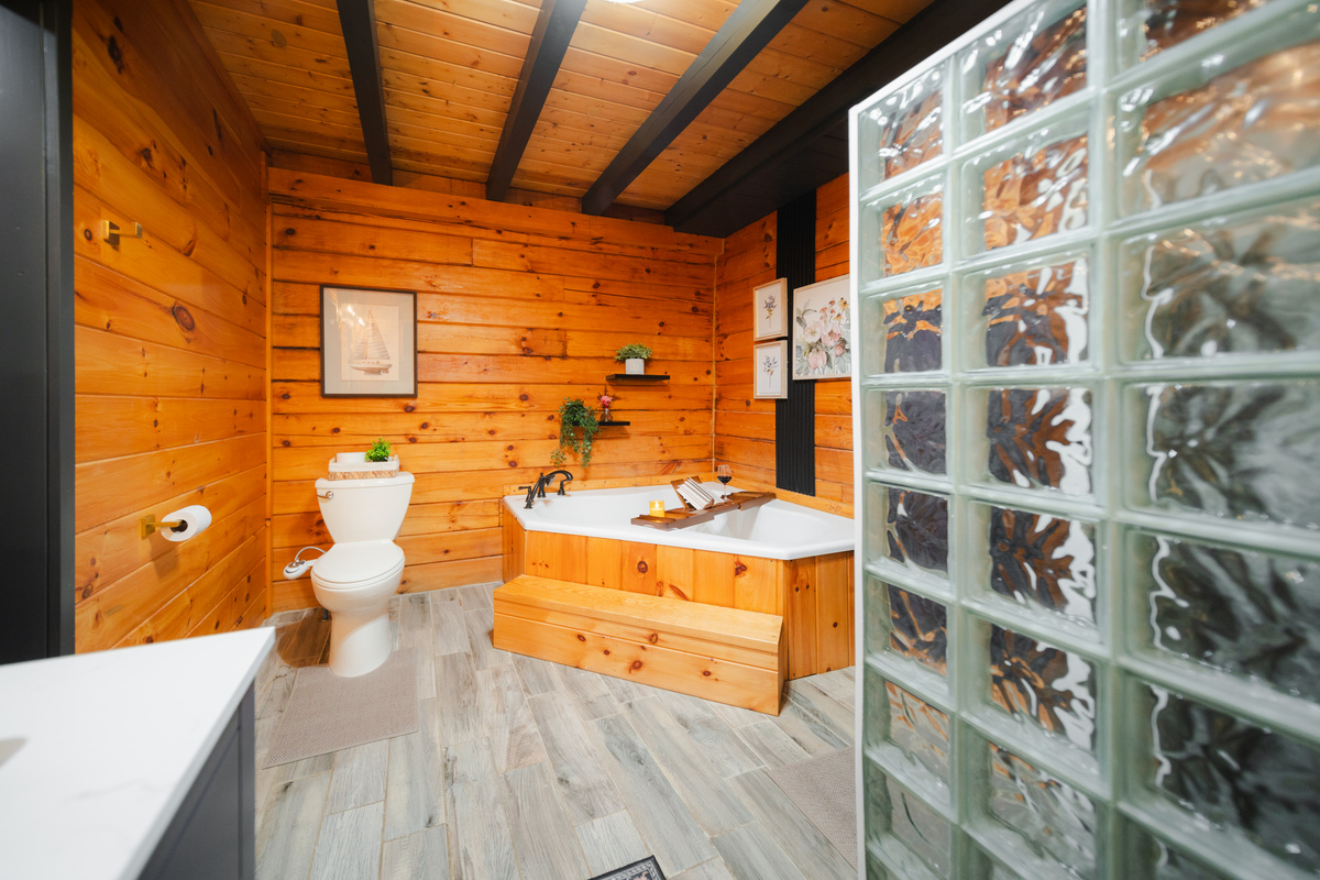 Another view of the primary bathroom, highlighting the spacious soaking tub and relaxing, spa-inspired atmosphere.