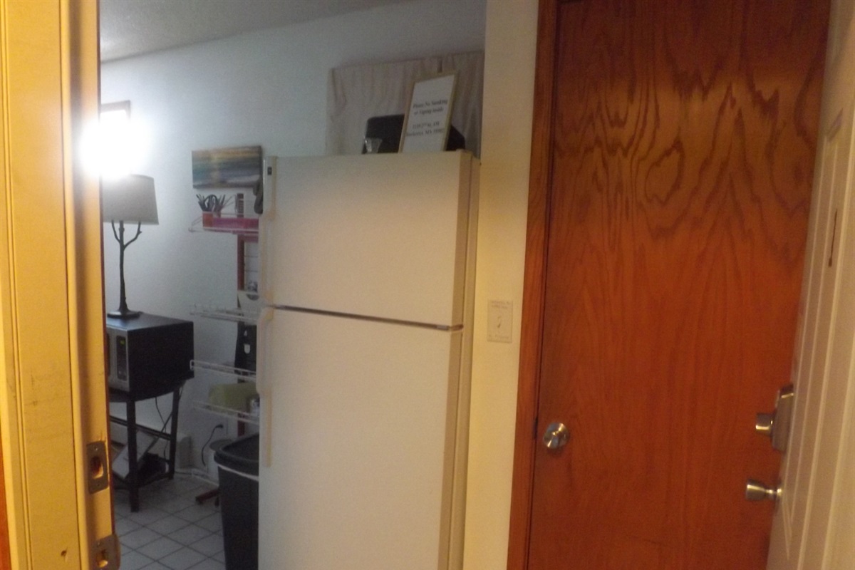 Full kitchen with refrigerator, stove, microwave, coffee makers, and most essentials