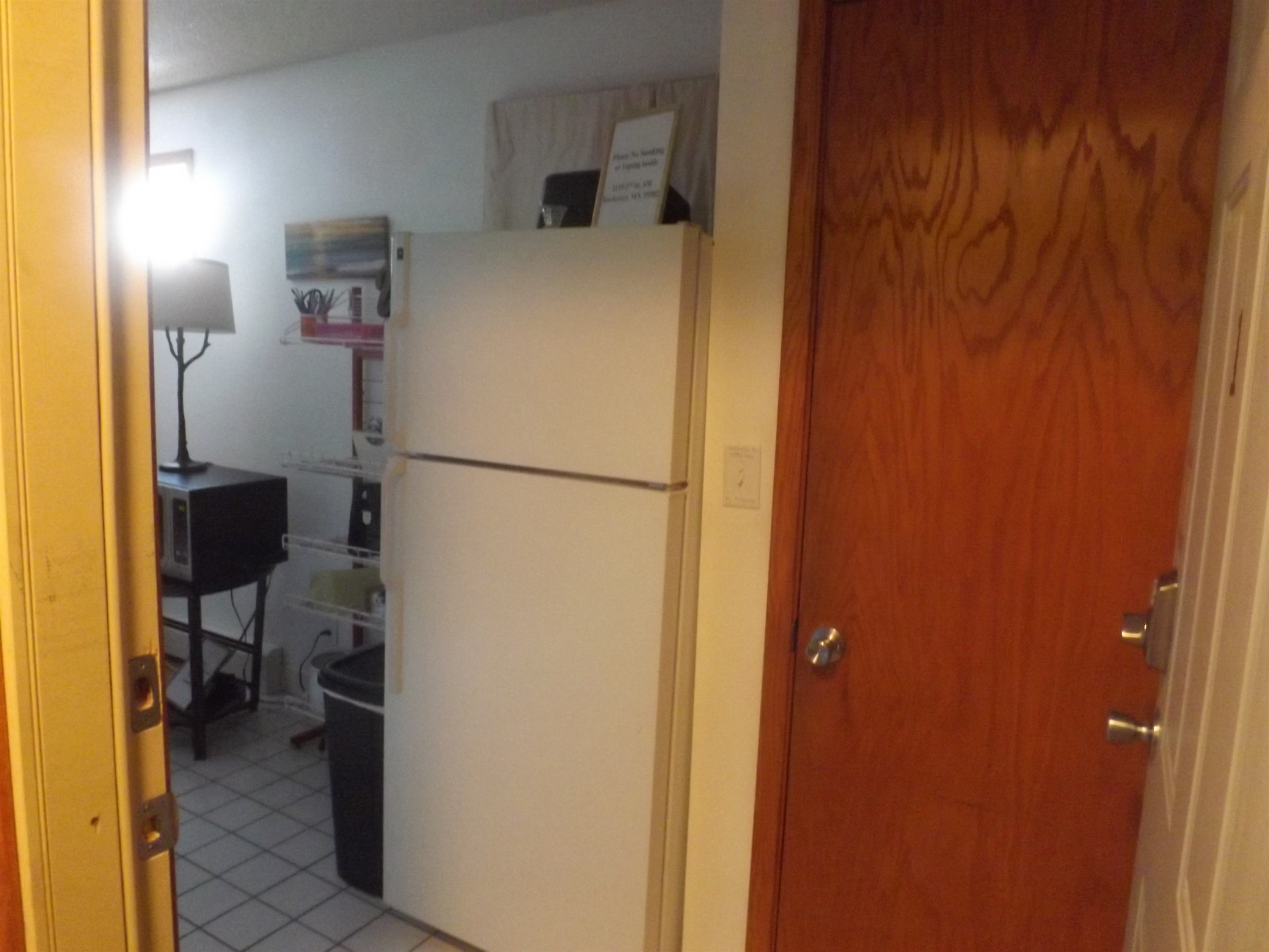 Full kitchen with refrigerator, stove, microwave, coffee makers, and most essentials