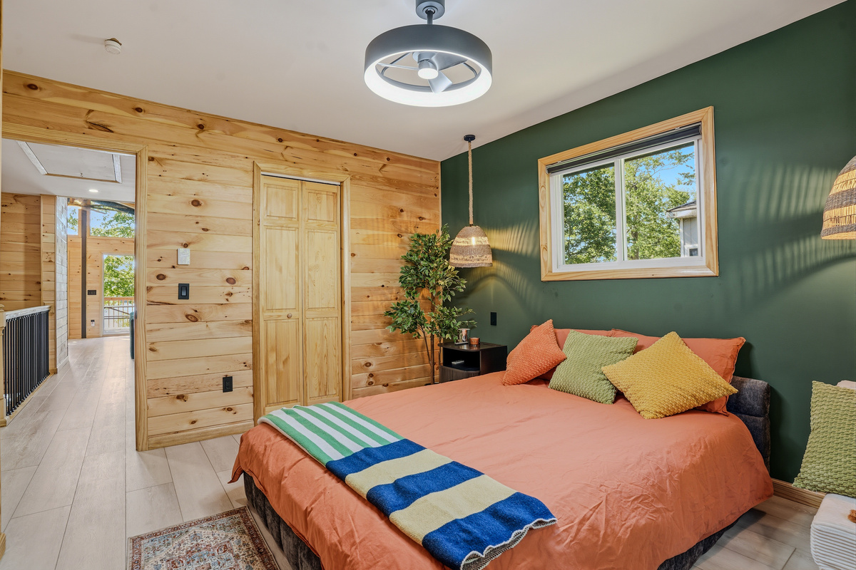 Queen bedroom from alternate angle showing full layout and closet access