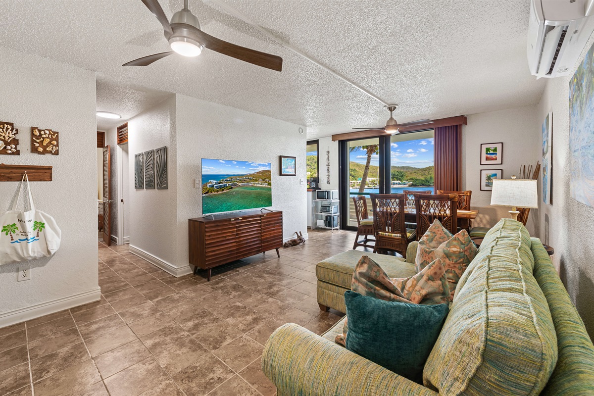 the hallway off of the living room leads to the bedrooms and bathrooms