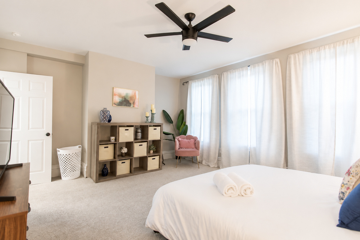 Discover the King Bedroom, a spacious room on the second floor with king bed flanked by nightstands with lamps.